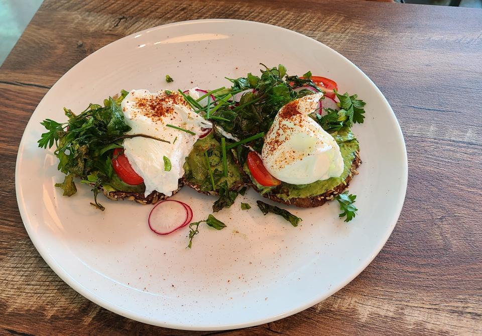 Fogg Cafe's avocado toast topped with eggs.