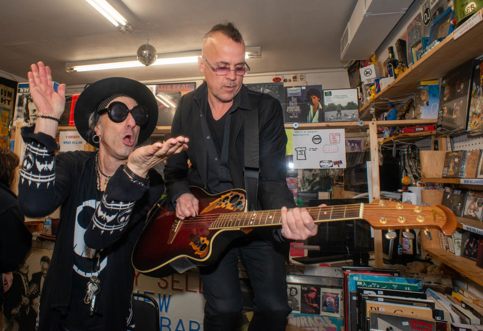 WMMR Radio Personality Jacky Bam Bam (left) sings along as musician Chris Day performs for customers during Record Store Day at Positively Records in Levittown. The store opened from midnight to 2 a.m. for the day that celebrates independent record shops, vinyl and music.