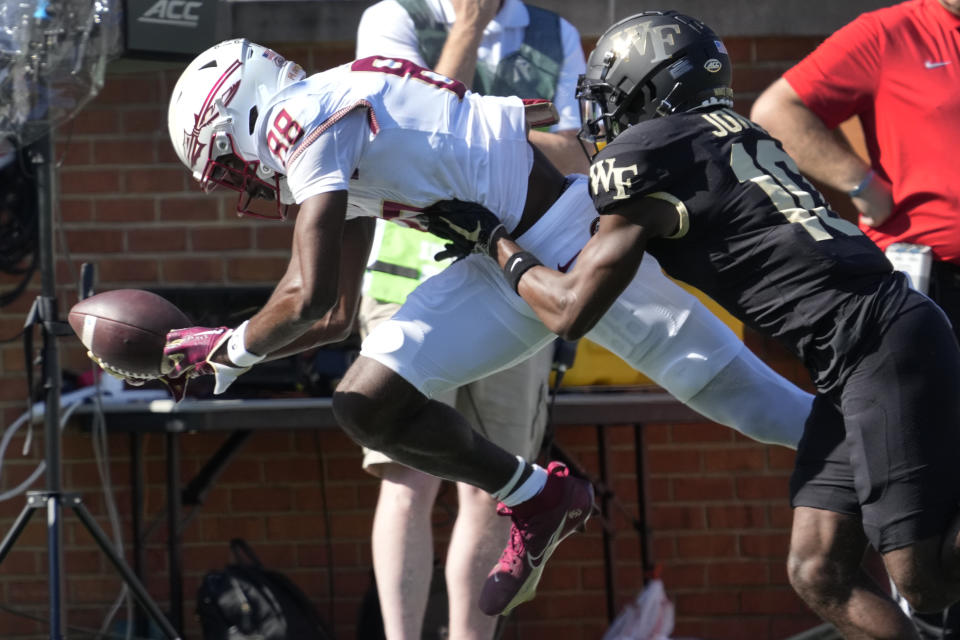 Florida State wide receiver Kentron Poitier (88) catches a pass as Wake Forest defensive back DaShawn Jones (10) defends during the first half of an NCAA college football game in Winston-Salem, N.C., Saturday, Oct. 28, 2023. (AP Photo/Chuck Burton)