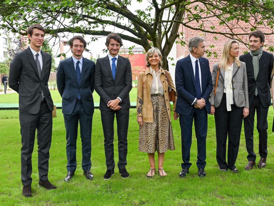 LVMH CEO Bernard Arnault poses with five children and wife outside