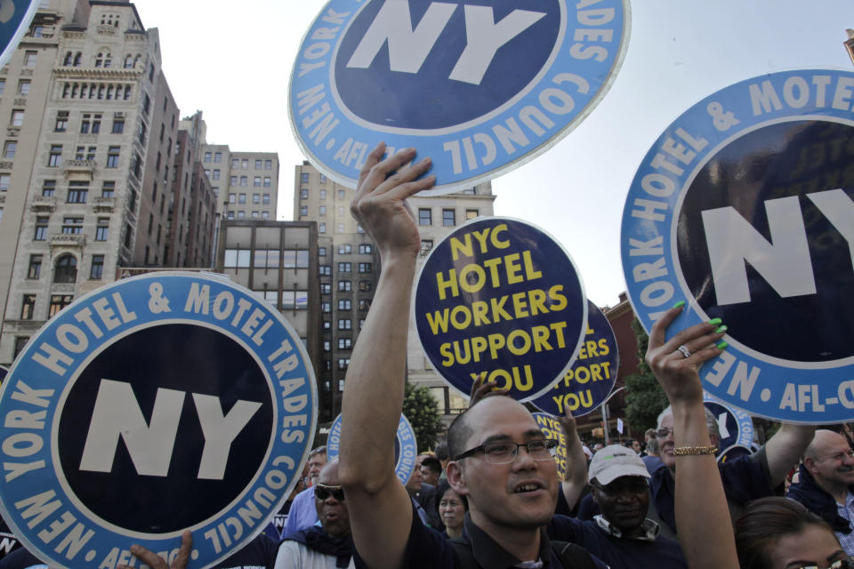Hotel union workers raise signs and chant during a protest rally to support low-wage workers as part of National Day of Action in New York, Tuesday, July 24, 2012. (AP Photo/Bebeto Matthews)