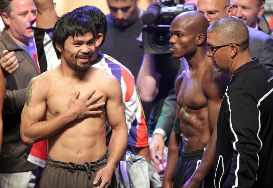Boxers Manny Pacquiao (L) and Timothy Bradley during the weigh-in on June 8, 2012, for their bout at the MGM Grand Hotel/Casino in Las Vegas, Nevada. Pacquiao weigh-in at 147 lbs. Bradley weigh-in at 146 lbs. Pacquiao will defend his WBO welterweight title against Bradley when the two meet in the ring on June 9 at the MGM Grand Garden Arena in Las Vegas. AFP PHOTO / John GURZINSKIJOHN GURZINSKI/AFP/GettyImages