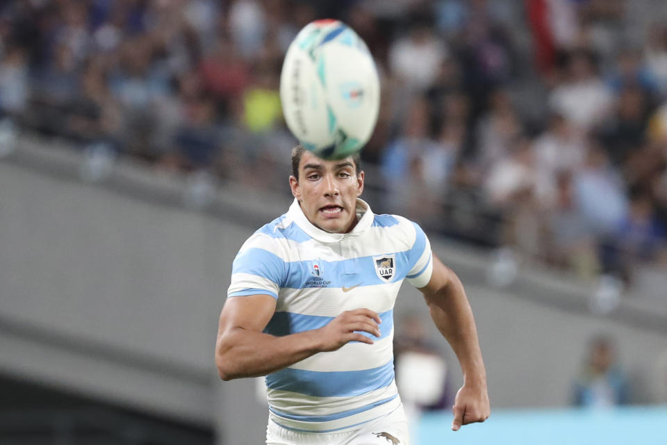 Argentina's Santiago Carreras chases a ball during the Rugby World Cup Pool C game at Tokyo Stadium between France and Argentina in Tokyo, Japan, Saturday, Sept. 21, 2019. (AP Photo/Eugene Hoshiko)