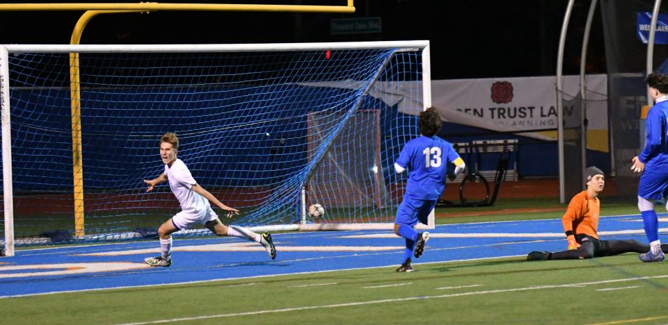 Agoura's Devin Bening (left)) celebrates as the ball goes into the back of the net for a goal in the Chargers' 3-0 win over host Westlake on Friday night. Agoura clinched its second straight Marmonte League title.
