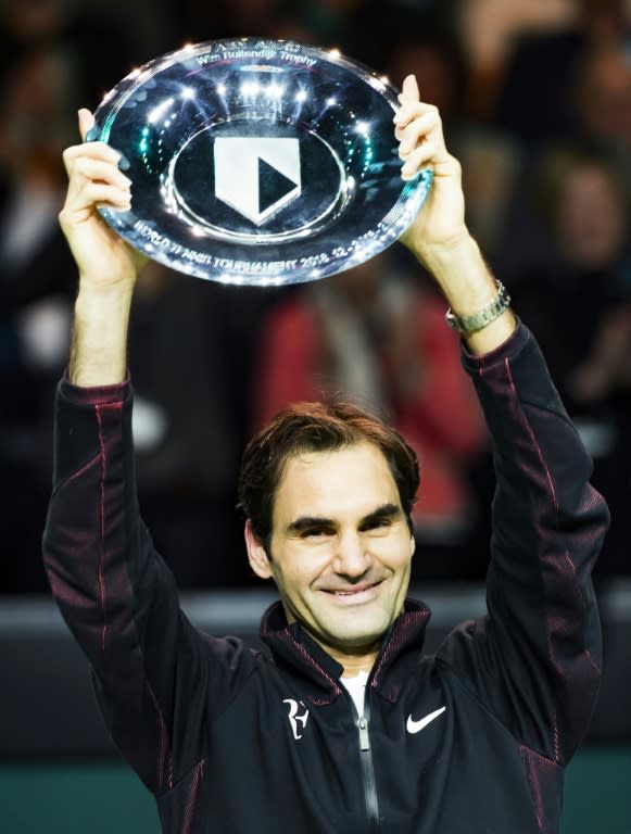 Champion class: Federer holds aloft his trophy