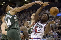 Toronto Raptors forward OG Anunoby (3) vies for a loose ball with Milwaukee Bucks forward Giannis Antetokounmpo (34) during the second half of an NBA basketball game Tuesday, Feb. 25, 2020, in Toronto. (Nathan Denette/The Canadian Press via AP)