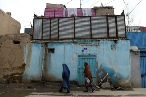 Women walk along a street in the old part of Kabul -- for many in Afghanistan, fear of violence has been replaced by dread the insurgents will crack down on freedoms