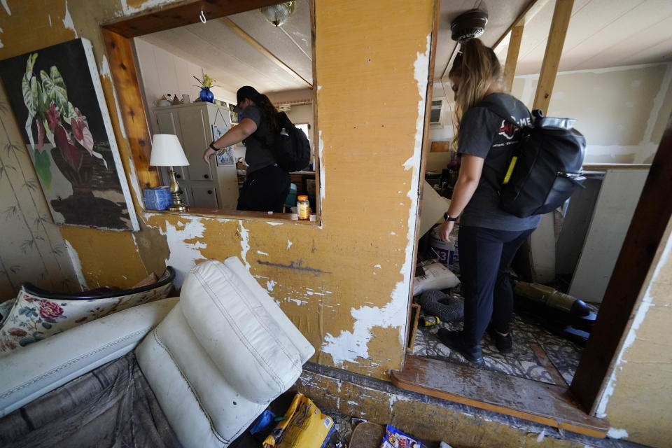 Members of mediccorps.org search a home in Pine Island, Fla., whose resident was known to have stayed behind when Hurricane Ian bore down on Florida but has not been heard from since, Saturday, Oct. 1, 2022. Paramedics and volunteers with mediccorps.org arrived on the island with two helicopters as the only bridge to get there was heavily damaged so access is limited to boat or air. (AP Photo/Gerald Herbert)