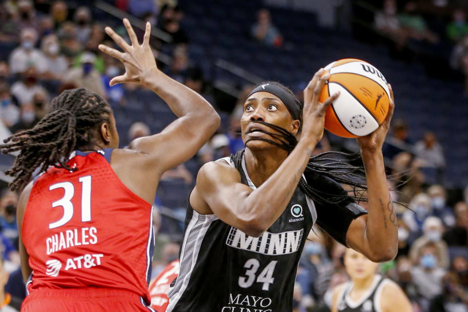 FILE - Minnesota Lynx center Sylvia Fowles (34) shoots over Washington Mystics center Tina Charles (31) in the first quarter of a WNBA basketball game on Sept. 4, 2021, in Minneapolis. The WNBA will begin its 26th season this weekend with many fascinating storylines including the potential retirement of Sue Bird and Sylvia Fowles, the return of Becky Hammon as a coach and the absence of Brittney Griner. (AP Photo/Bruce Kluckhohn, File0