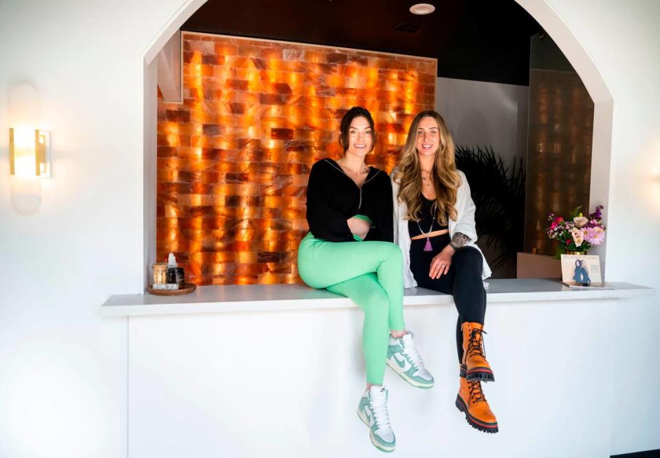 The Studio Modern Pilates owner Lindsey Naglieri, left, and Flow State Body Work owner Kelley Johnson, right, pose for a portrait in the lobby of the new Pilates, Body and Breath work center they opened together on March 13th in Gig Harbor, Wash.