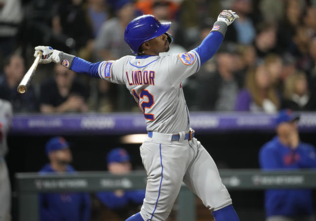 New York Mets' Francisco Lindor follows the flight of his sacrifice fly that drove in a run off Colorado Rockies relief pitcher Brad Hand in the ninth inning of a baseball game Friday, May 26, 2023, in Denver. (AP Photo/David Zalubowski)