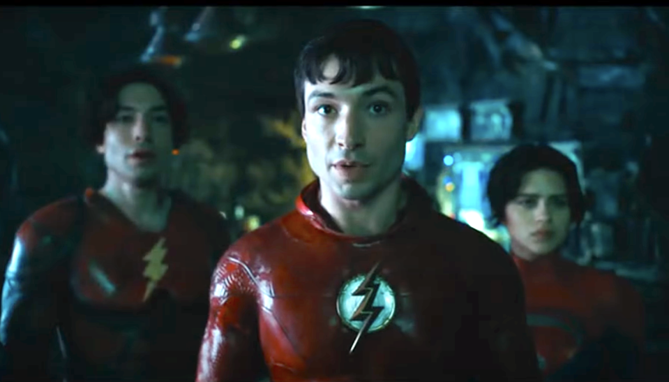 ezra miller wearing red superhero costume with lightning bolt logo in the flash