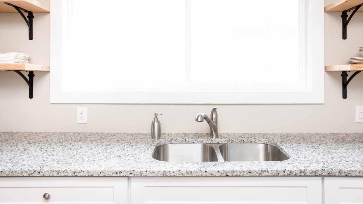 Kitchen sink with white kitchen cabinets