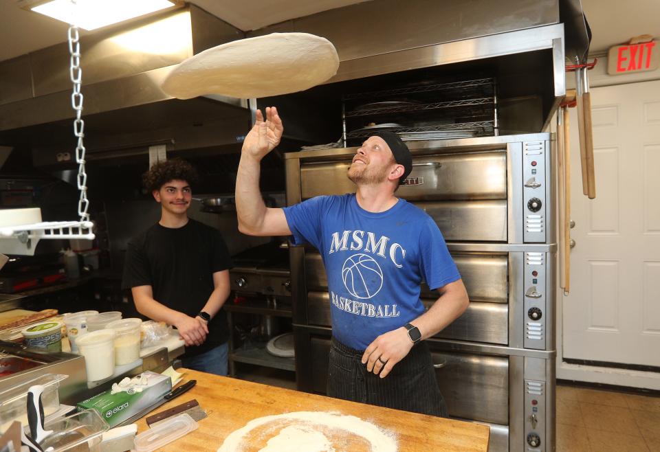 Paul Padoleski tosses pizza dough at Salty Bread Pizza Cafe in Irondequoit. 