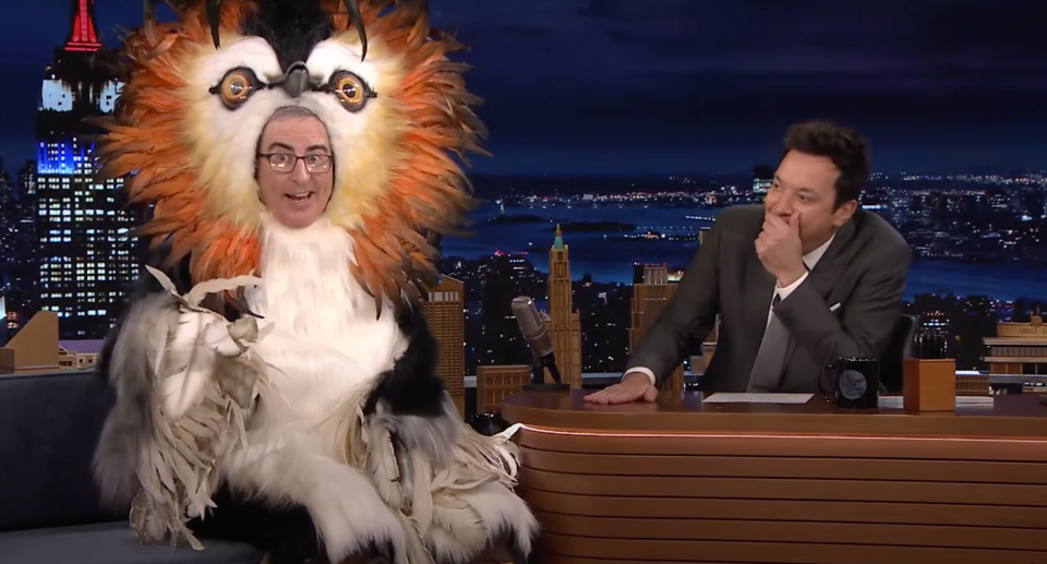 Comedian John Oliver is dressed as a giant pūteketeke next to Jimmy Fallon.