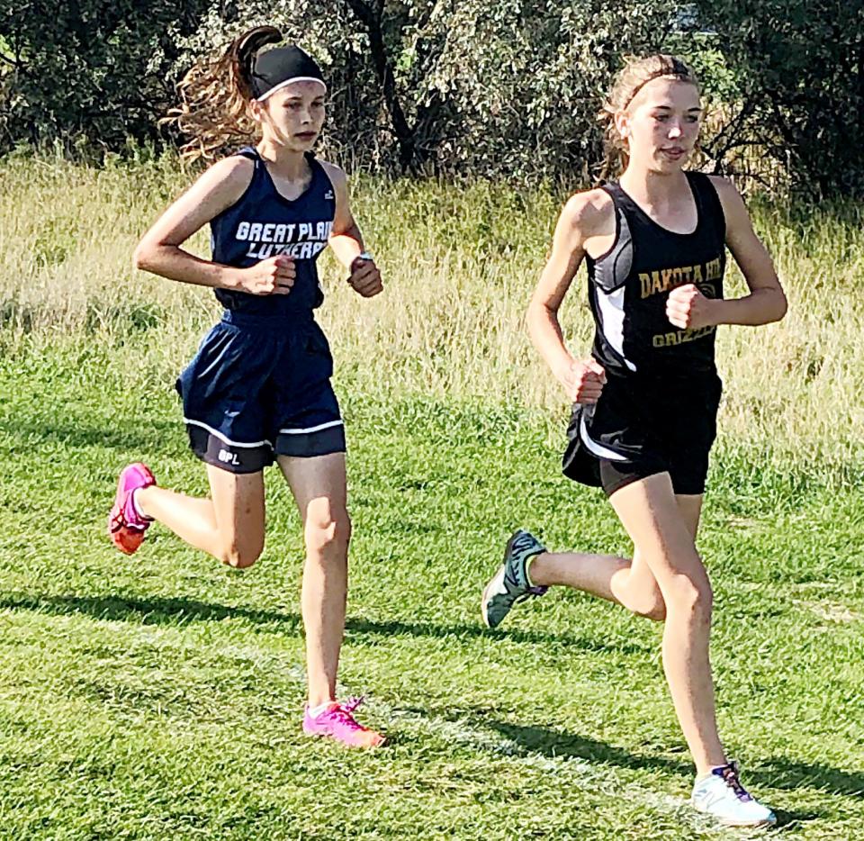 Great Plains Lutheran junior Halle Bauer, shown chasing Madison Zirbel of Dakota Hills in a race last fall, spearheads a strong group of returnees for the 2022 Panther boys and girls cross country teams. Bauer won the Eastern Coteau Conference and Region 1A meets last fall and finished eighth in the state Class A race.