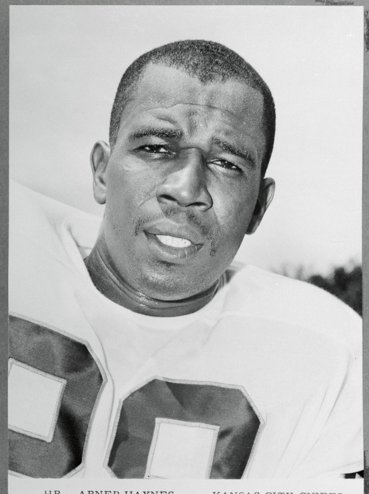 Abner Haynes of The Kansas City Chief runs with football.