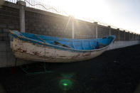 A wooden boat carrying the remains of migrant belongings is seen at the Arinaga port in Gran Canaria island, on Wednesday, Aug. 19, 2020. Some 4,000 migrants have reached the Canaries so far this year, the most in over a decade, raising alarm at the highest levels of the Spanish government. (AP Photo/Emilio Morenatti)