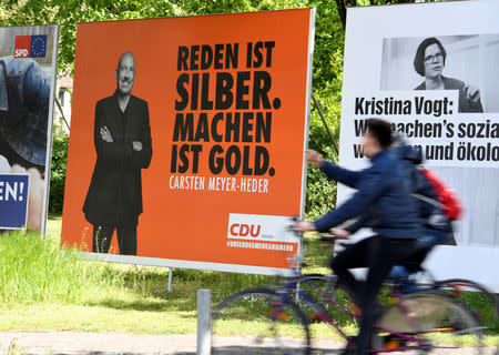 Election posters of Carsten Meyer-Heder, Germany's Christian Democrats Union (CDU) top candidate, and Kristina Vogt, top candidate of the German left-wing Die Linke party, are seen in Bremen, Germany May 4, 2019. REUTERS/Fabian Bimmer