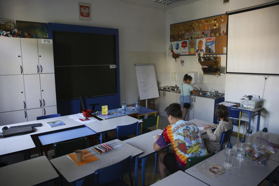 Ukrainian refugee children sit in classroom at the Lauder Morasha Jewish school in Warsaw, Poland, Thursday, July 28, 2022. A special summer camp run by Jewish organizations has brought Jewish volunteers from the former Soviet Union to Warsaw to help Ukrainian children. The camp, which ran for most of July and ended Friday, was organized to bring some joy to traumatized children, help prepare them for the school year ahead in Polish schools and give their mothers some time to themselves. (AP Photo/Michal Dyjuk)