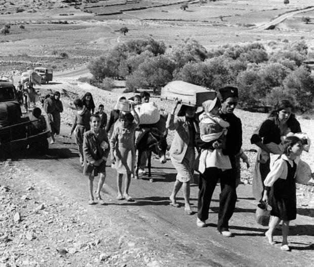 A group of Arab refugees walks along a road from Jerusalem to Lebanon, carrying their belongings with them on Nov. 9, 1948. In 2023, for the first time, the United Nations commemorated the flight of hundreds of thousands of Palestinians from what is now Israel on the 75th anniversary of their exodus, an action stemming from the U.N.’s partition of British-ruled Palestine into separate Jewish and Arab states. 