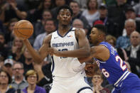 Memphis Grizzlies forward Jaren Jackson Jr.,left, looks to pass against Sacramento Kings guard Kent Bazemore, right, during the first quarter of an NBA basketball game Thursday, Feb. 20, 2020, in Sacramento, Calif. (AP Photo/Rich Pedroncelli)