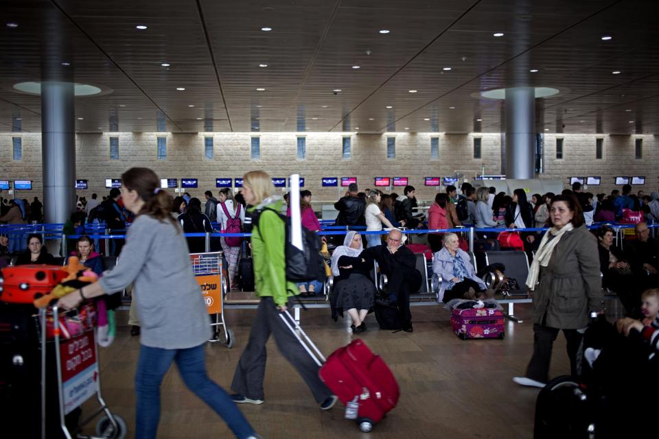 Passengers wait in a departure hall at the Ben Gurion airport near Tel Aviv, Israel, Sunday, April 21, 2013. Israel's three airlines went on strike Sunday over a proposed "Open Skies" deal with the European Union that union workers say jeopardizes their jobs and could even cause the local airline industry to collapse. (AP Photo/Ariel Schalit)