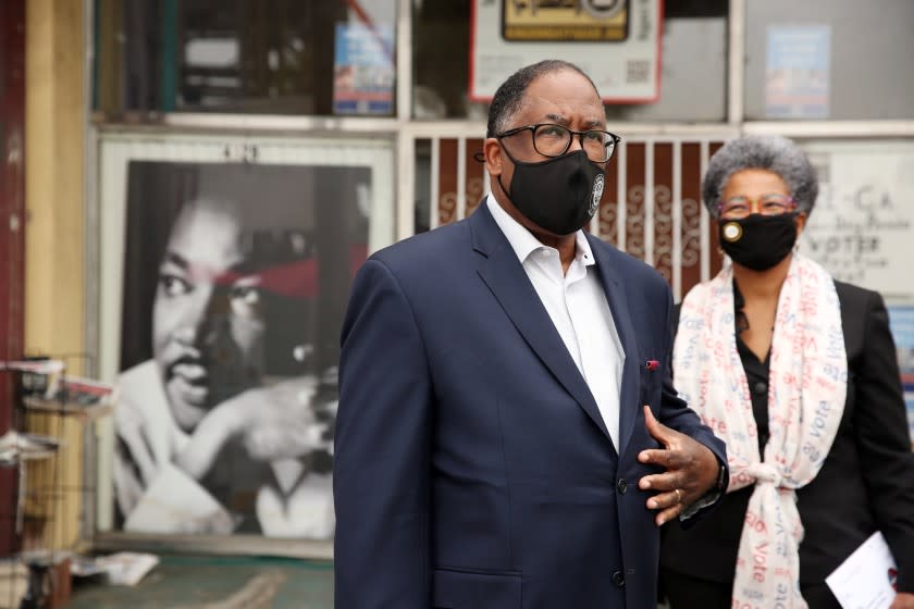 LOS ANGELES, CA - NOVEMBER 03: Los Angeles County Supervisor Mark Ridley-Thomas speaks to the press before casting his vote with wife Avis Ridley-Thomas, right, at Hot and Cool Cafe in Leimert Park on Tuesday, Nov. 3, 2020 in Los Angeles, CA. Mark Ridley-Thomas is running against attorney Grace Yoo for a seat on the Los Angeles City Council that is vacated by Councilman Herb Wesson. (Dania Maxwell / Los Angeles Times)