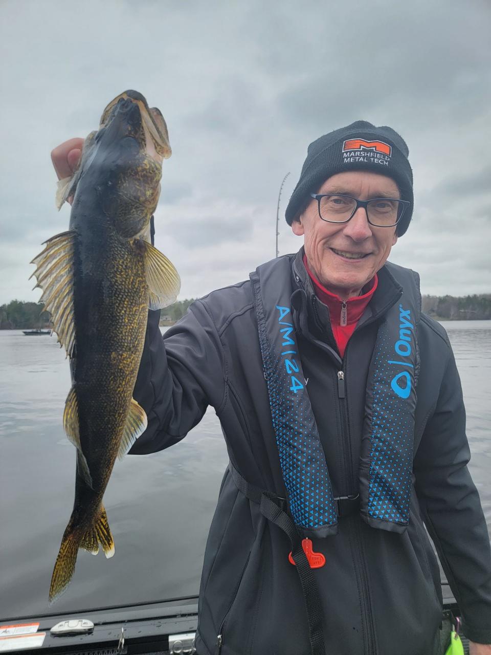 Gov, Tony Evers holds a 23-inch-long walleye he caught Saturday on the Phillips Chain in Phillips, site of the 2023 Governor's Fishing Opener.