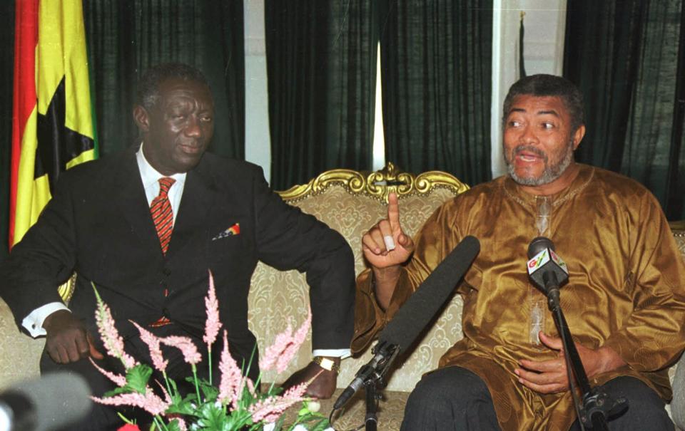FILE - In this Jan. 3, 2001 file photo, outgoing President Jerry Rawlings of Ghana, right, meets with President-elect John Kufuor, left, as they hold discussions on the transfer of power in Accra, Ghana. Ghana's former president Jerry Rawlings, who staged two coups and later led the West African country's transition to a stable democracy, has died aged 73, according to the state's Radio Ghana and the president Thursday, Nov. 12, 2020. (AP Photo/ Clement Ntaye, File)