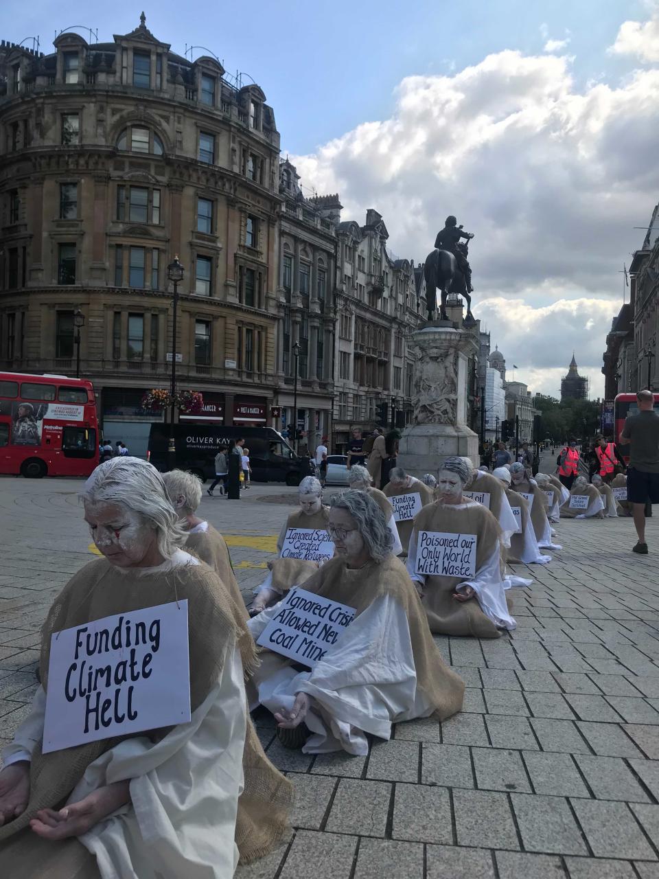 The placards had regrets such as ‘funding climate hell’ and ‘ignoring scientists’ (Holly Bancroft/The Independent)