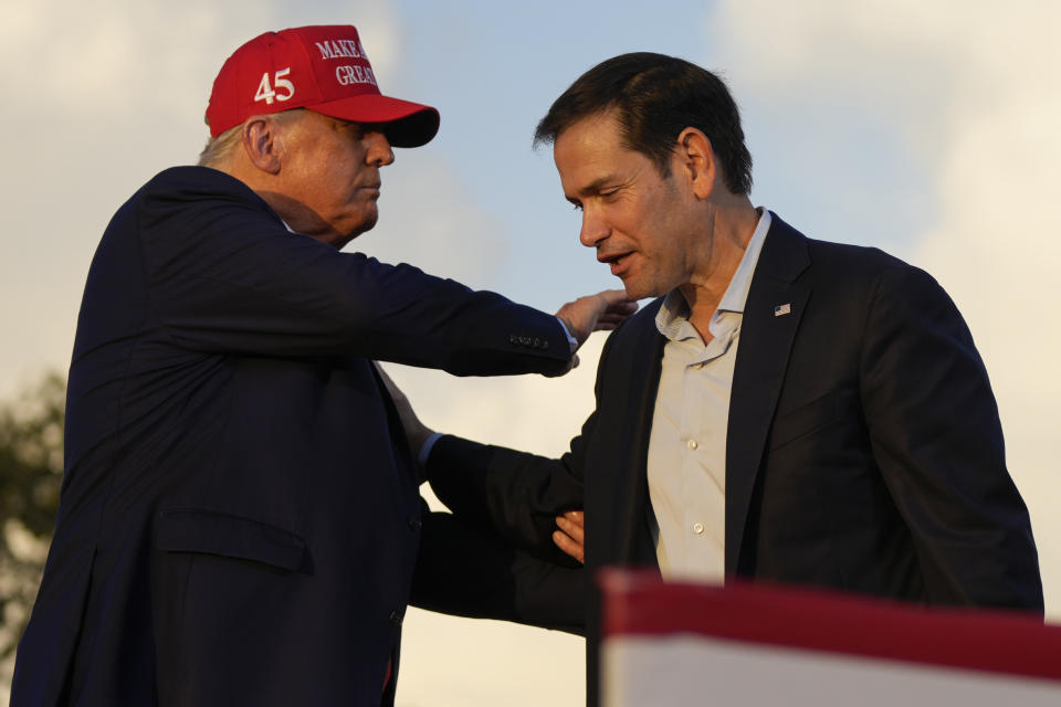Former President Donald Trump pats Sen. Marco Rubio, R-Fla., on the shoulder at a campaign rally at the Miami-Dade County Fair and Exposition on Sunday, Nov. 6, 2022, in Miami. (AP Photo/Rebecca Blackwell)