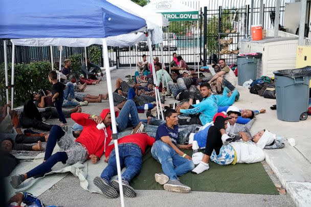 PHOTO: Recently arrived migrants wait in a garage area of the U.S. Customs and Border Protection - Marathon Border Patrol Station, on Jan. 4, 2023, in Marathon, Fla. (Wilfredo Lee/AP)