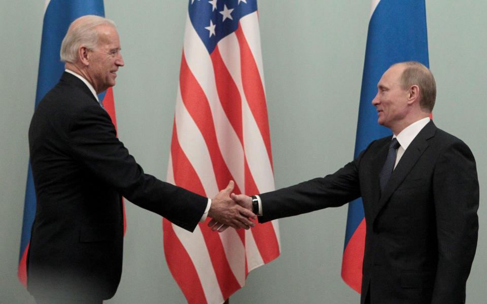 Mr Putin, then Russia's prime minister, and Mr Biden, then US vice president, shake hands during a meeting in Moscow in 2011 - Alexander Natruskin /REUTERS