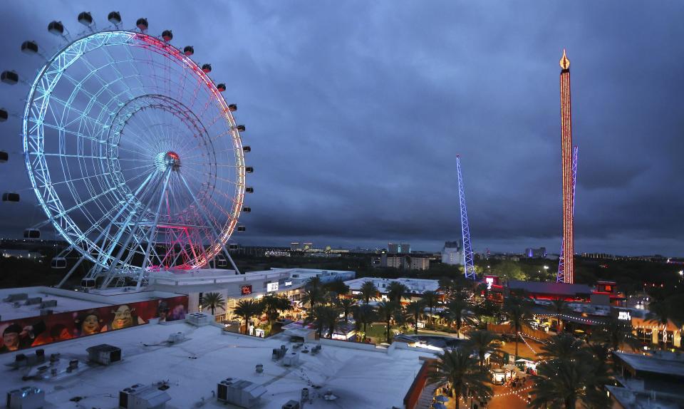 ICON Park attractions, The Wheel, left, Orlando SlingShot, middle, and Orlando FreeFall, right, are shown in Orlando, Fla., on Thursday, March 24, 2022. A 14-year-old boy fell to his death from a ride at an amusement park in Orlando, sheriff's officials said. Sheriff's officials and emergency crews responded to a call late Thursday at Icon Park, which is located in the city's tourist district along International Drive. The boy fell from the Orlando Free Fall ride, which opened late last year.(Stephen M. Dowell /Orlando Sentinel via AP)