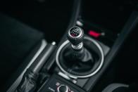<p>The six-speed manual transmission and center differential controls, as well as the engine mode selector, are all familiar.</p>