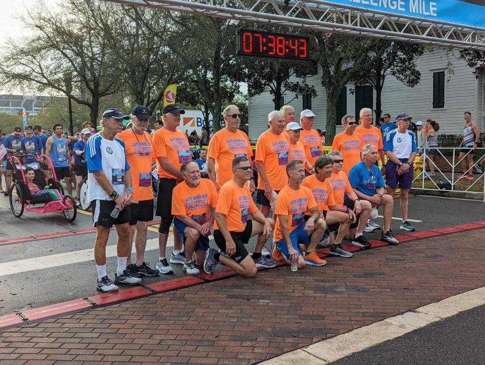 The 18 remaining streakers, runners to complete every edition of the Gate River Run, gather at the start line of the race in Jacksonville on March 2, 2024. [Clayton Freeman/Florida Times-Union]