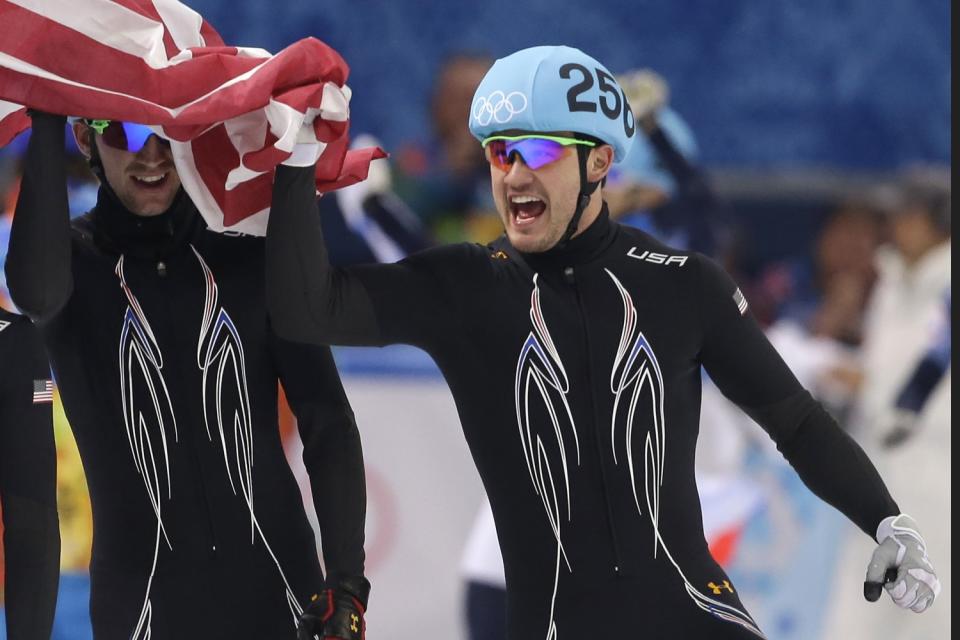 Eddy Alvarez celebrates with teammates after winning silver in the men's short track speedskating 5,000-meter relay.