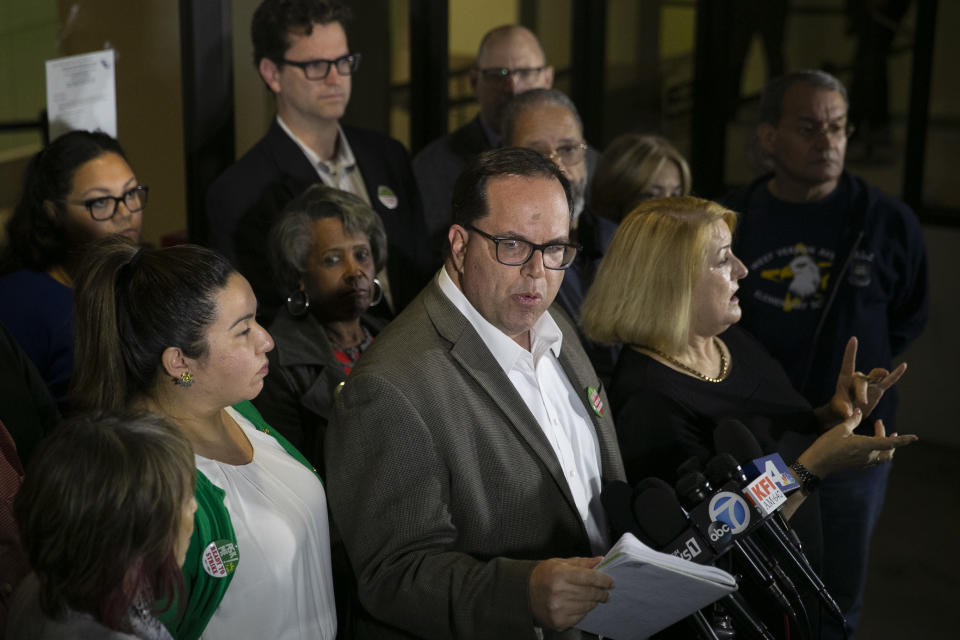 United Teachers Los Angeles union president Alex Caputo-Pearl, center, speaks during a news conference at the Los Angeles Unified School District headquarters Wednesday, Jan. 9, 2019, in Los Angeles. The union representing teachers in Los Angeles, the nation's second-largest school district, postponed the start of a strike until Monday because of the possibility of a court-ordered delay of a walkout. (AP Photo/Jae C. Hong)