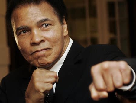 U.S. boxing great Muhammad Ali poses during the Crystal Award ceremony at the World Economic Forum (WEF) in Davos, Switzerland January 28, 2006. REUTERS/Andreas Meier/Files