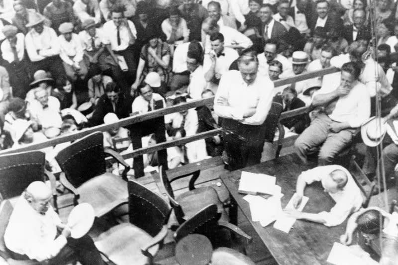 Photograph shows William Jennings Bryan (seated, L) and Clarence Darrow (standing, C) at an outdoor courtroom during the Scopes Trial in Dayton, Tenn., in July 1925. UPI File Photo