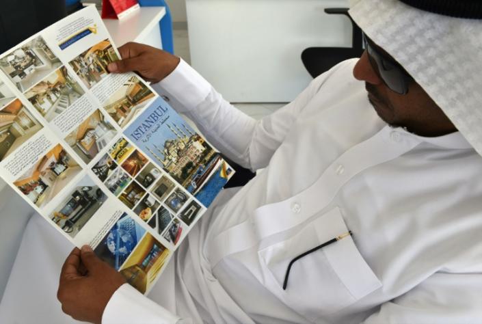 A Saudi customer reads a tourist leaflet about Turkey at a travel agency in Riyadh, amid fears a downturn in visitors could hurt the fragile Turkish economy (AFP Photo/FAYEZ NURELDINE)
