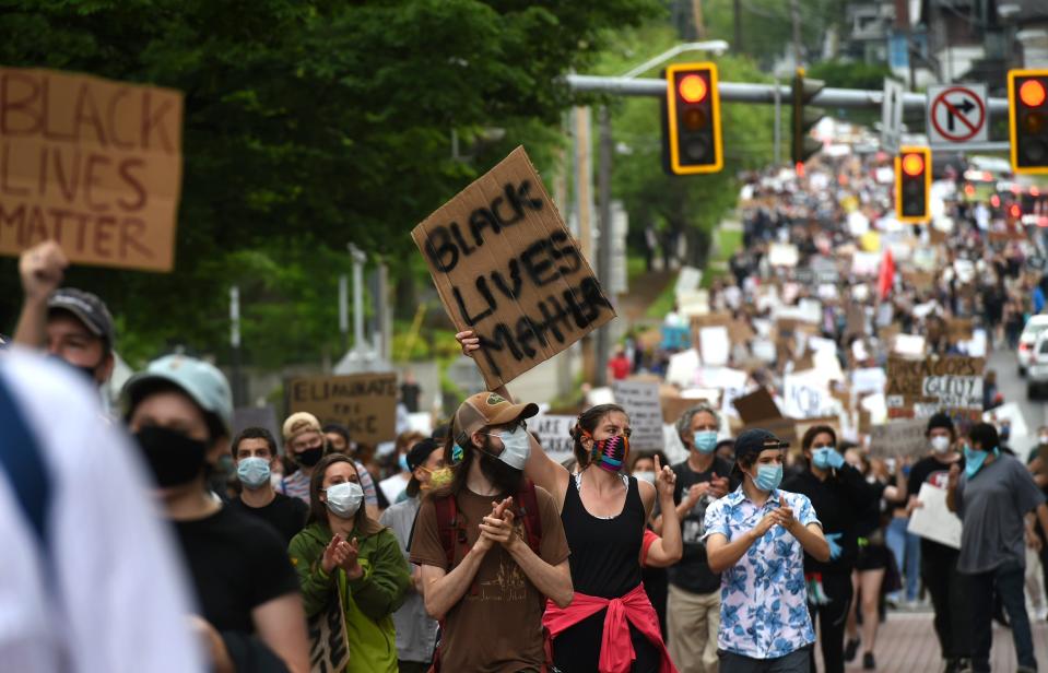 Hundreds of protesters march down a street in Ithaca, N.Y., as part of the March 4 Floyd, a peaceful protest against police brutality and systematic oppression on Wednesday, June 3, 2020.