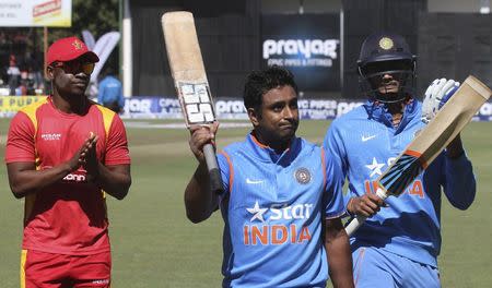 Indian batsman Ambati Rayudu (C) salutes the crowd as he leaves the field after scoring 124 not out during their first One Day International cricket match against Zimbabwe in Harare, July 10, 2015. Also pictured: Zimbabwe's Chamunorwa Chibhabha (L) and India's Axar Patel (R). REUTERS/Philimon Bulawayo
