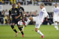 Orlando City's Mauricio Pereyra, right, kicks the ball past Columbus Crew's Darlington Nagbe during the first half of an MLS soccer match Wednesday, Oct. 27, 2021, in Columbus, Ohio. (AP Photo/Jay LaPrete)