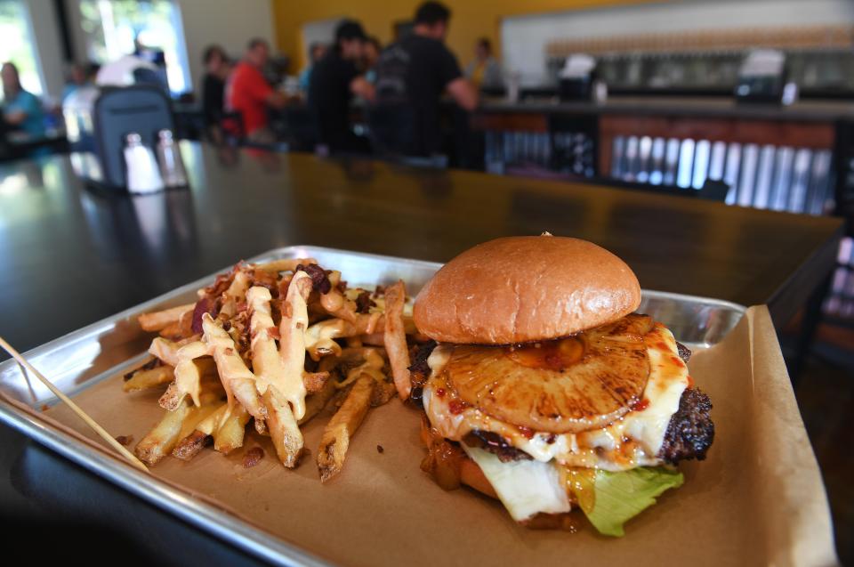 Holliday Brewing has opened a location in Inman. The business features a wide range of foods and a selection of beers. One of the items on the menu is the 'Smash Burger' that comes several ways - this is the Holliday in Paradise: grilled pineapple, Swiss, lettuce, and sweet chili sauce.
