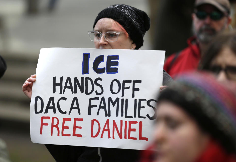 FILE - In this Feb. 17, 2017 file photo, a protester holds a sign that reads "ICE Hands Off DACA Families Free Daniel," during a demonstration in front of the federal courthouse in Seattle. On Friday, March 24 2017, a federal judge upheld a decision not to release Daniel Ramirez Medina, a Mexican man who was arrested near Seattle, despite his participation in a program designed to protect those brought to the U.S. illegally as children, saying Ramirez should challenge his detention in immigration court. (AP Photo/Ted S. Warren, file)