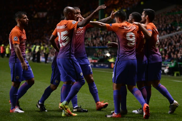 Manchester City's Fernandinho (2L) and teammates congratulate Raheem Sterling (2R) after he scored his team's second goal during the UEFA Champions League match against Celtic on September 28, 2016