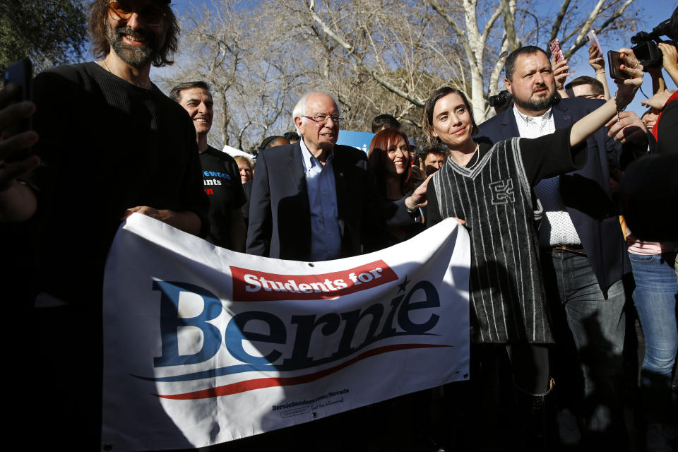 Democratic presidential candidate Sen. Bernie Sanders, I-Vt., leads supporters to an early voting location after a campaign event at the University of Nevada, Las Vegas, Tuesday, Feb. 18, 2020, in Las Vegas. (AP Photo/Patrick Semansky)