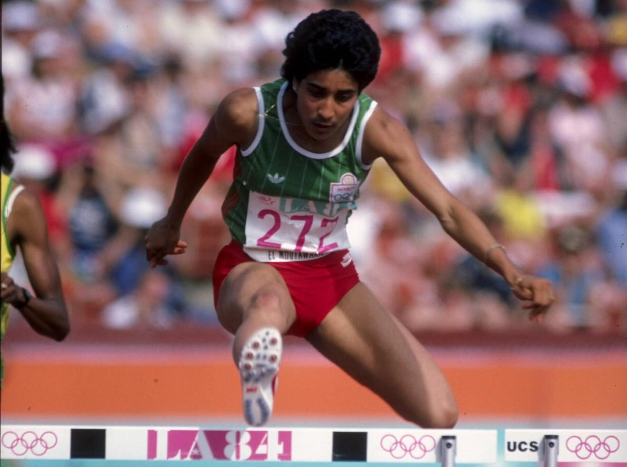 Nawal El Moutawakel of Morocco clears a hurdle during the inaugural Women's 400 metres hurdles event at the XXIII Olympic Summer Games on 8th August 1984 at the Los Angeles Memorial Coliseum in Los Angeles, California, United States. (Photo by Tony Duffy/Allsport/Getty Images)